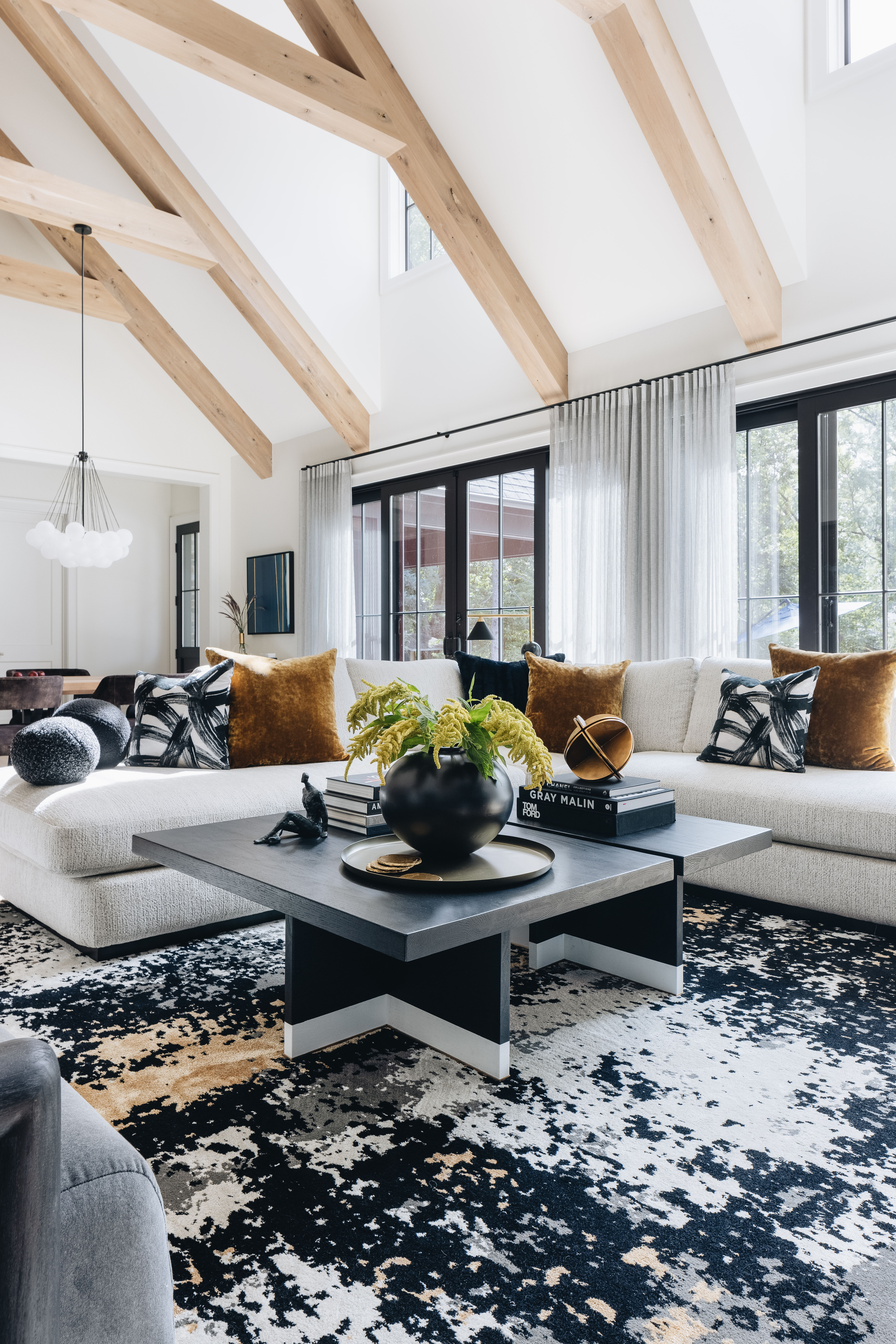 Dining room with exposed timber beams and sculptural lighting
